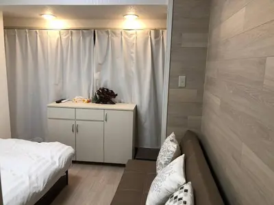 a small bedroom with a bed and a couch at Shinjuku 102 in Tokyo