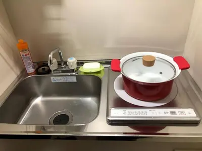 a pot on a stove next to a sink at Shinjuku 102 in Tokyo