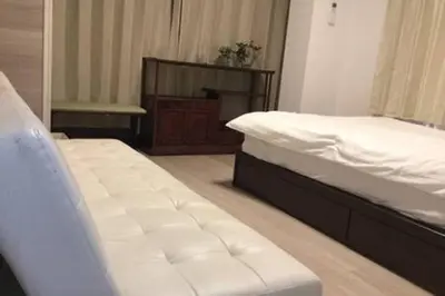 two twin beds in a room with a tv at Shinjuku 102 in Tokyo
