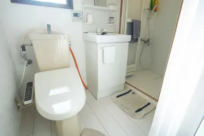 a bathroom with a toilet and a sink and a shower at Shinjuku 102 in Tokyo