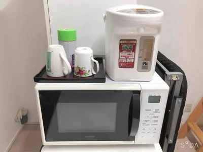 a microwave with a coffee maker on top of it at Shinjuku 102 in Tokyo