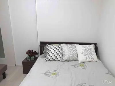 a bed with pillows on it in a bedroom at Shinjuku 102 in Tokyo