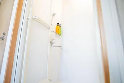 a shower with a hose attached to a door at Shinjuku 102 in Tokyo