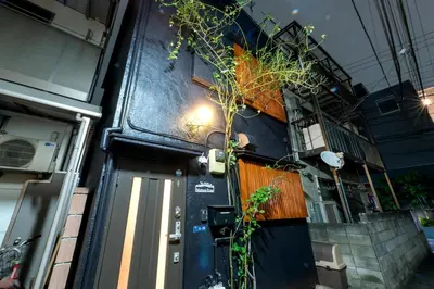 a front door of a building with a plant on it at Y's INN MaisonRose 106T in Tokyo