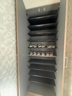 a walk in closet with black shelves at Asakusa\u5708\u99c5\u304b\u30898\u5206\u65e5\u5f0f\u72ec\u680b\u522b\u5885 in Tokyo