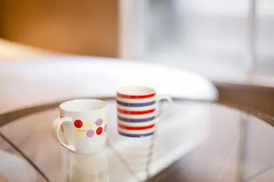 two coffee mugs sitting on a glass table at International Hotel Kabukicho in Tokyo