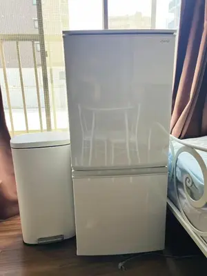 two white refrigerators are sitting next to each other at \u677e\u5c4b Hotel in Tokyo