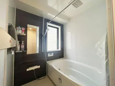 a bathroom with a white tub and a window at \u677e\u5c4b Hotel in Tokyo