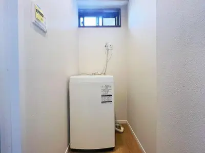 a white refrigerator in a room with a window at \u677e\u5c4b Hotel in Tokyo
