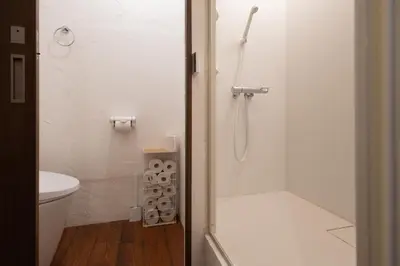 a bathroom with a shower and a toilet at \u30ca\u30ab\u30ce\u30b3\u30df\u30c1 Nakanokomichi in Tokyo