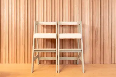 a white chair in front of a wooden wall at \u51ea\u30ce\u5bb6\u66f3\u821f Naginoya Hikihune in Tokyo