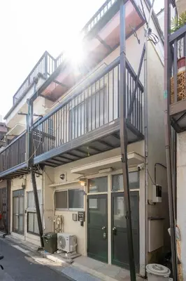 a building with a staircase on the side of it at \u51ea\u30ce\u5bb6\u66f3\u821f Naginoya Hikihune in Tokyo