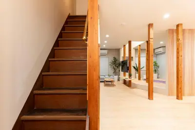 a staircase in a house with wooden floors at \u51ea\u30ce\u5bb6\u66f3\u821f Naginoya Hikihune in Tokyo