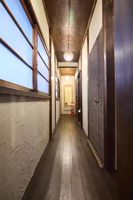 a hallway in an old building with wooden floors and windows at Tokyo Ninja \u5c4b\u6577 in Tokyo