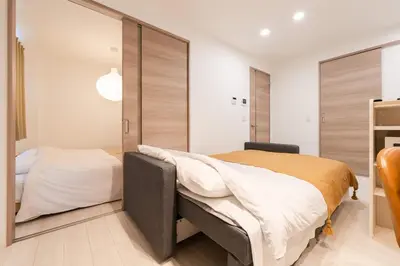 a bedroom with a large bed and a closet at House Hotel EKODA 2F HE2122 in Tokyo