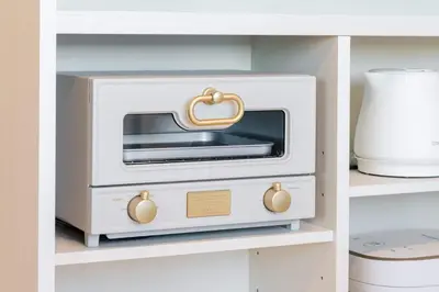a kitchen with a toaster oven in a cabinet at House Hotel EKODA 2F HE2122 in Tokyo