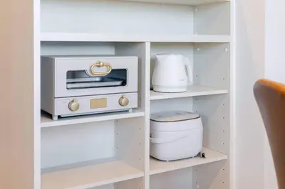 a white cabinet with a toaster oven and a toaster at House hotel EKODA 1F 3F HE1131 in Tokyo