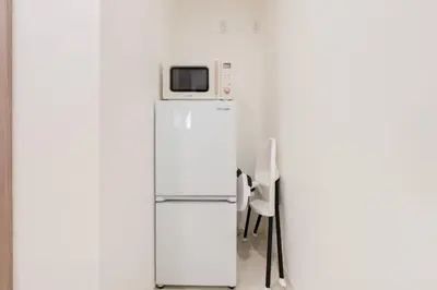 a white refrigerator with a microwave on top of it at House hotel EKODA 1F 3F HE1131 in Tokyo