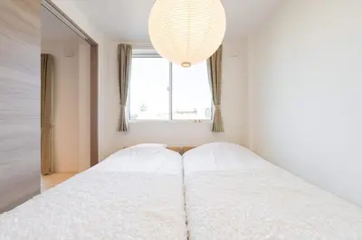 a bedroom with a white bed with a large window at House hotel EKODA 1F 3F HE1131 in Tokyo