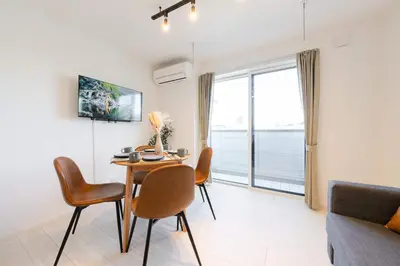 a living room with a table and chairs and a large window at House hotel EKODA 1F 3F HE1131 in Tokyo