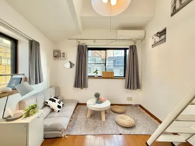 a living room with a couch and a table at Shinjuku Terasu BA in Tokyo