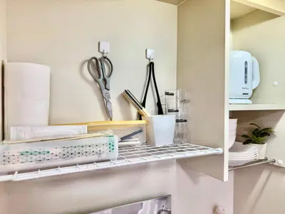 a kitchen shelf with scissors and other kitchen utensils at Shinjuku Terasu BA in Tokyo