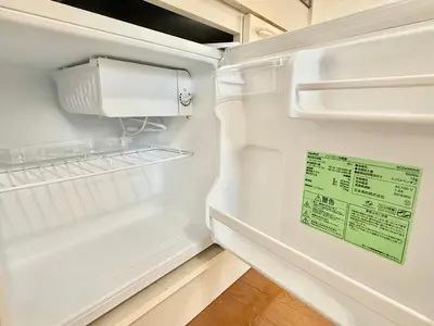 an empty refrigerator with a sign in the door at Shinjuku Terasu BA in Tokyo
