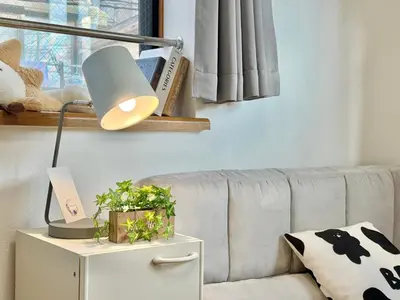 a lamp on a side table next to a couch at Shinjuku Terasu BA in Tokyo