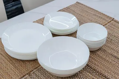 four white plates sitting on top of a table at SPACESHIP UNIT1 122Ta in Tokyo