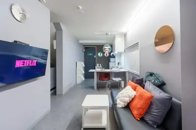 a living room with a couch and a table at SPACESHIP UNIT1 122Ta in Tokyo