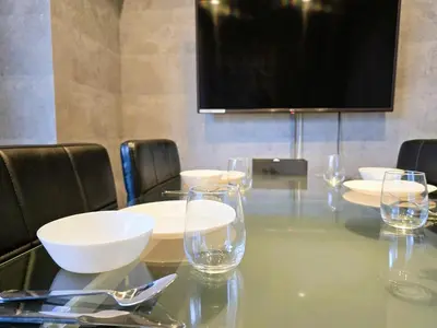 a table with wine glasses and a flat screen tv at Regalo Shibaura 501 - Vacation STAY 06260v in Tokyo