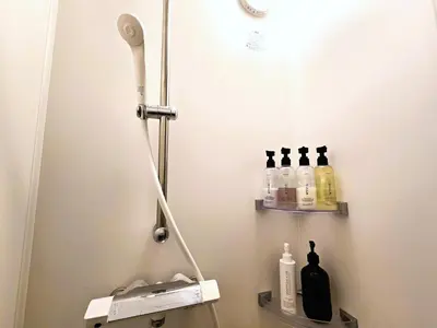 a bathroom with a shower with bottles on the wall at Regalo Shibaura 501 - Vacation STAY 06260v in Tokyo