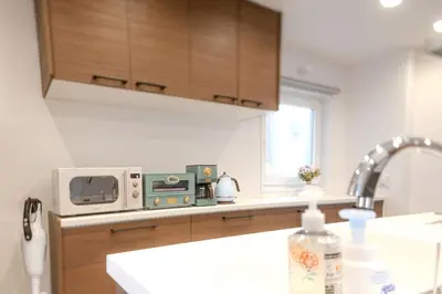 a kitchen with a sink and a microwave at Jessica House in Tokyo