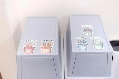 a refrigerator with three stickers of cats in cans at Jessica House in Tokyo