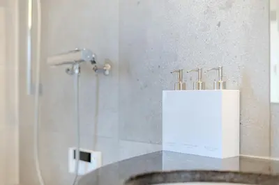 a bathroom with a counter with a box of tooth brushes at Jessica House in Tokyo