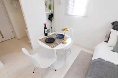 a white table and chairs in a room with a bed at LIVCITY Kinshicho 302 in Tokyo