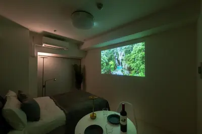 a bedroom with a bed and a tv on the wall at LIVCITY Kinshicho 302 in Tokyo