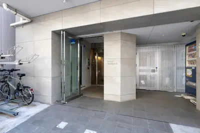 an entrance to a building with a bike parked outside at LIVCITY Kinshicho 402 in Tokyo