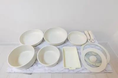 a group of white cups and plates on a table at LIVCITY Kinshicho 402 in Tokyo