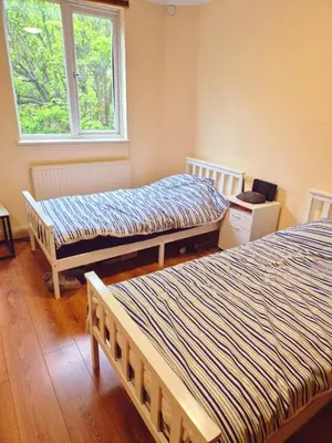 a room with two beds and a window at The class omote in Tokyo
