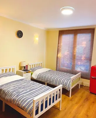 a bedroom with two beds and a window at The class omote in Tokyo