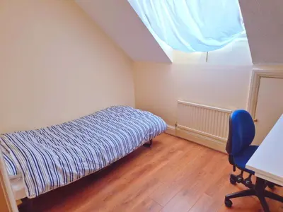 a bedroom with a bed and a desk and a window at The class omote in Tokyo