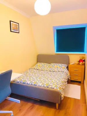 a small bedroom with a bed and a blue headboard at The class omote in Tokyo