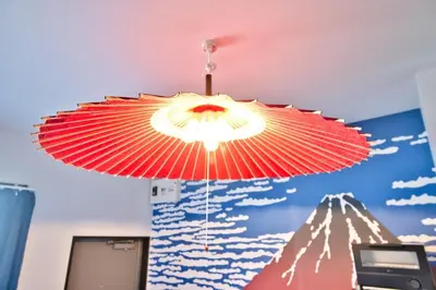 a red umbrella hanging from the ceiling of a room at Ikebukuro 10min Kanamecho 9min Max 2 NVF101 in Tokyo