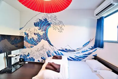 a bedroom with a mural of a wave on the wall at Ikebukuro 10min Kanamecho 9min Max 2 NVF101 in Tokyo