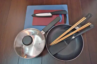 two frying pans and chop sticks on a table at Ikebukuro 10min Kanamecho 9min Max 2 NVF101 in Tokyo