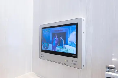 a flat screen tv hanging on a wall at LIVCITY Kinshicho 902 in Tokyo