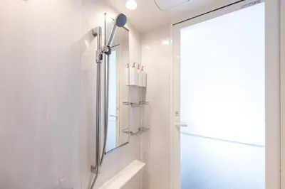 a bathroom with a shower and a mirror at LIVCITY Kinshicho 602 in Tokyo