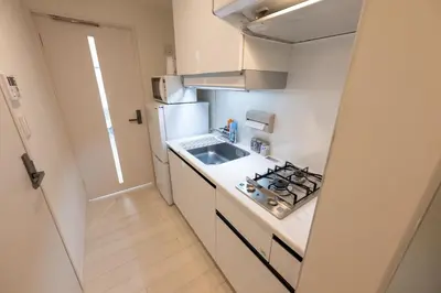 a small kitchen with a sink and a stove at LIVCITY Kinshicho 602 in Tokyo