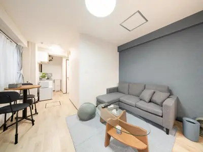 a living room with a couch and a table at Shibuya, 3min walk Ebisu Sta, 2min Harajuku Sta,Queen bed in Tokyo
